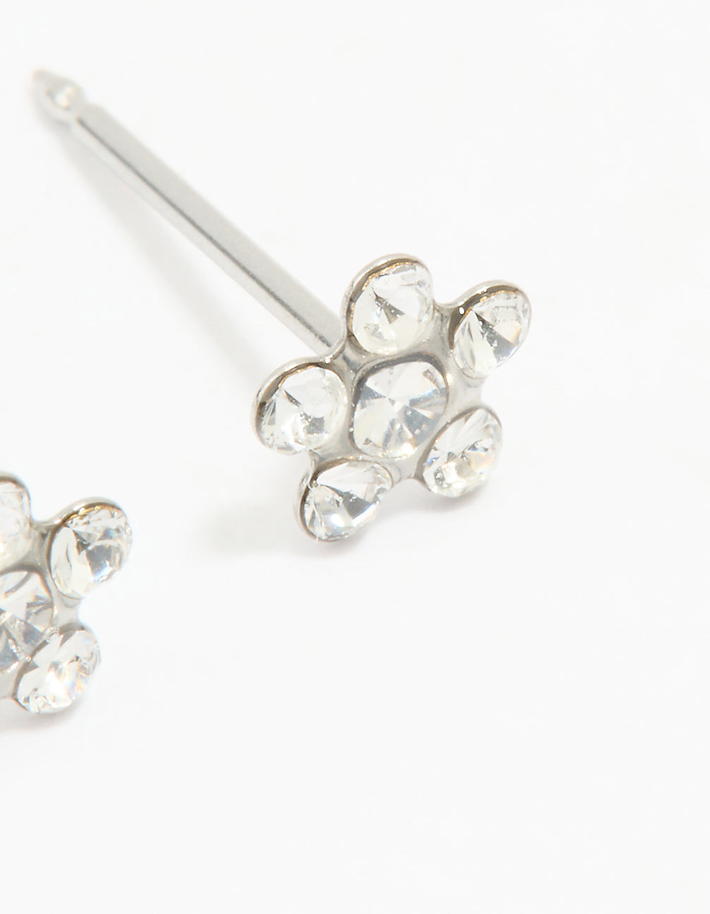 Explore dainty surgical stainless steel cubic zirconia daisy piercing studs with in silver and clear post detail view