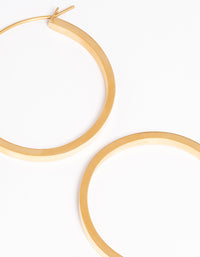 Displaying waterproof medium flat hoop earrings with gold plated stainless steel and hoop closure mechanism post detail view - link has visual effect only