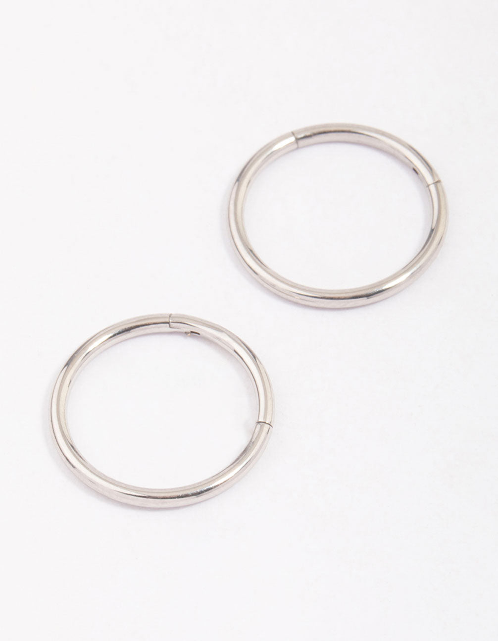 Discover dainty hoop closure earrings crafted from surgical steel in silver front view