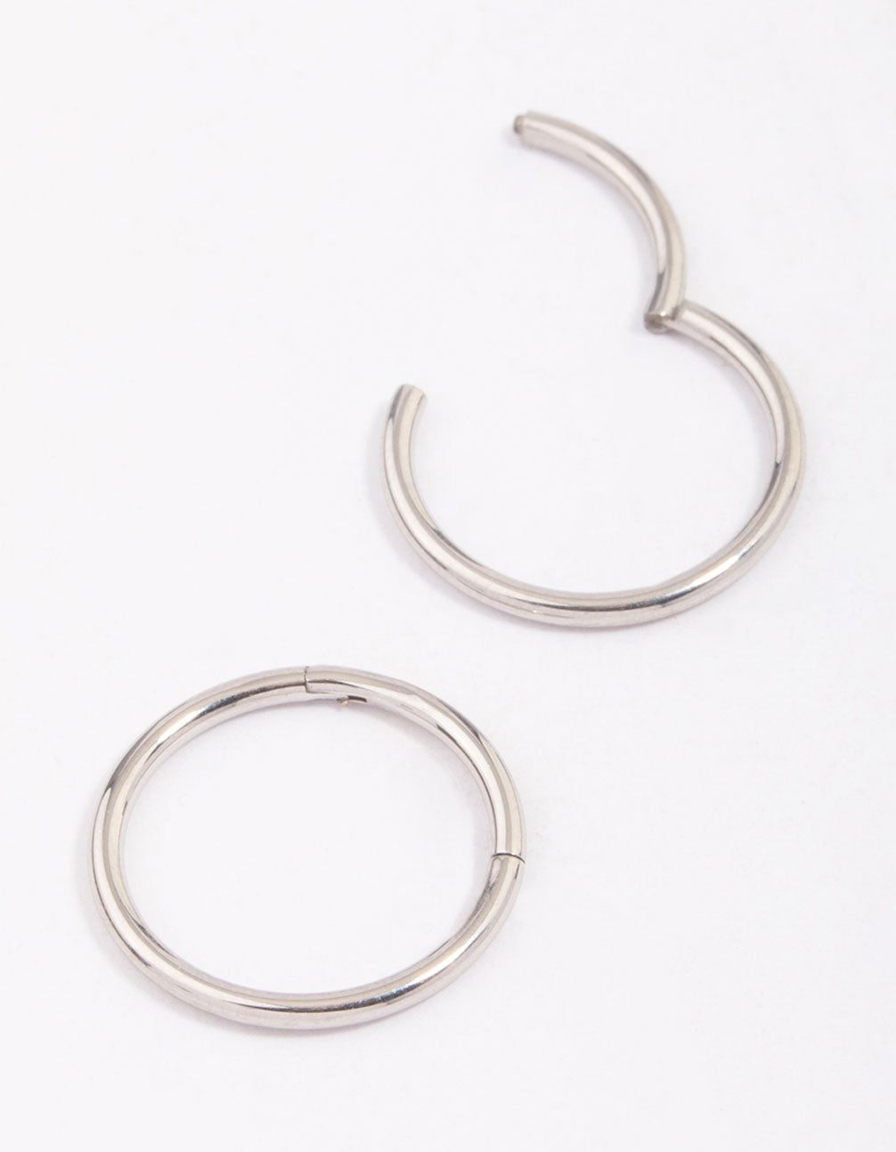 Explore dainty hoop closure earrings crafted from surgical steel in silver close up view