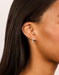 Showcasing sterling silver cubic zirconia drop stud earrings with celestial moon design in dainty style on ear view - link has visual effect only