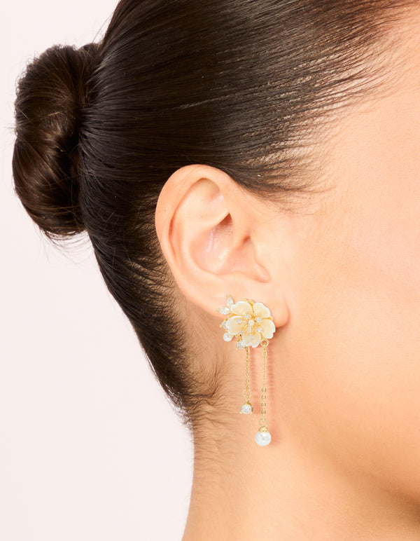Showcasing gold plated acrylic flower pearl drop earrings with statement style on ear view