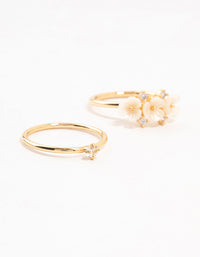 Showcasing gold plated triple flower stacking rings in a 3-pack close up view - link has visual effect only
