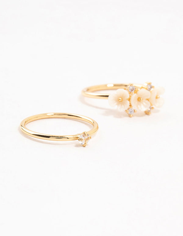 Showcasing gold plated triple flower stacking rings in a 3-pack close up view