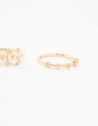 Highlighting gold plated triple flower stacking rings in a 3-pack side detail view - link has visual effect only