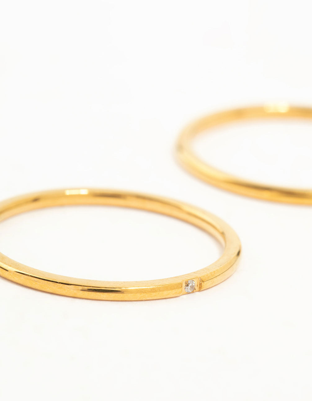 Crafted from waterproof gold plated stainless steel, these fine band rings feature a 2-pack design close up view