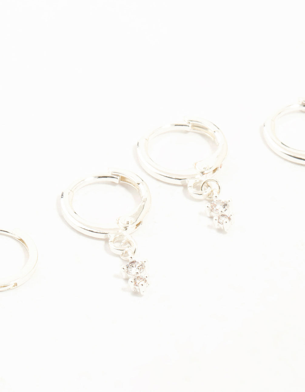 Featuring dainty charm hoop earrings with cubic zirconia in a 3-pack close up view