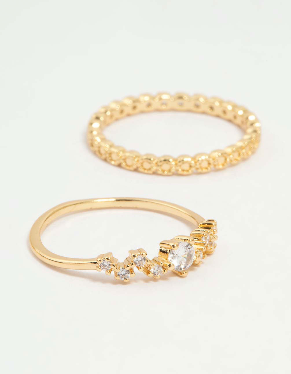 Highlighting gold plated squiggle and rope rings 5-pack with detailed band textures side detail view
