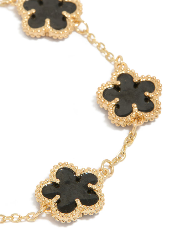 Featuring gold plated black flowers bracelet close up view