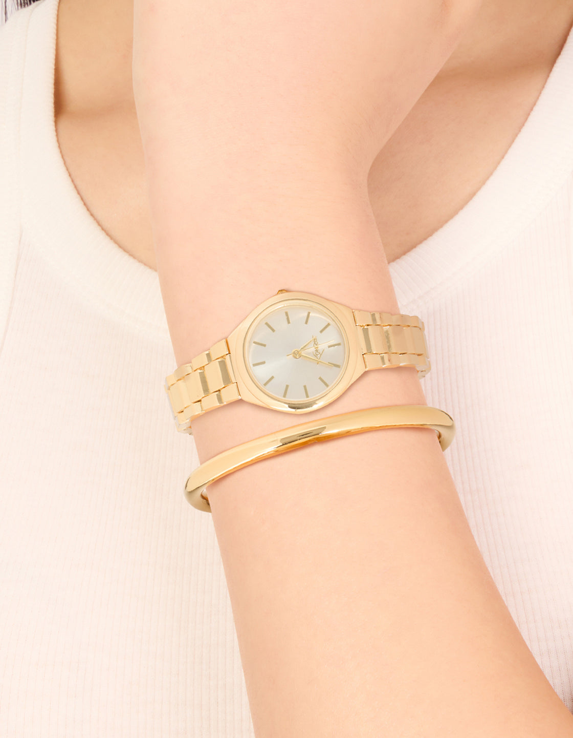 Featuring a classic wrist cuff and watch set in gold with white dial, round shape, link band strap, analog type, designed for women, casual occasion on wrist view