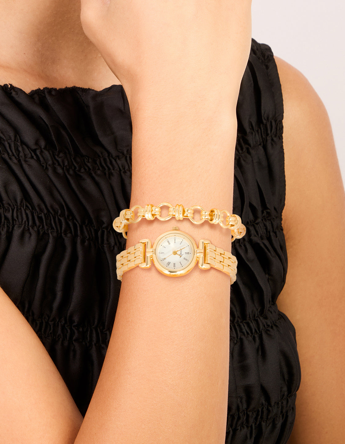 Crafted from gold chain bracelet and watch set with white dial, roman numerals, round shape, link band strap, designed for women, ideal for formal occasions in a statement style on wrist view