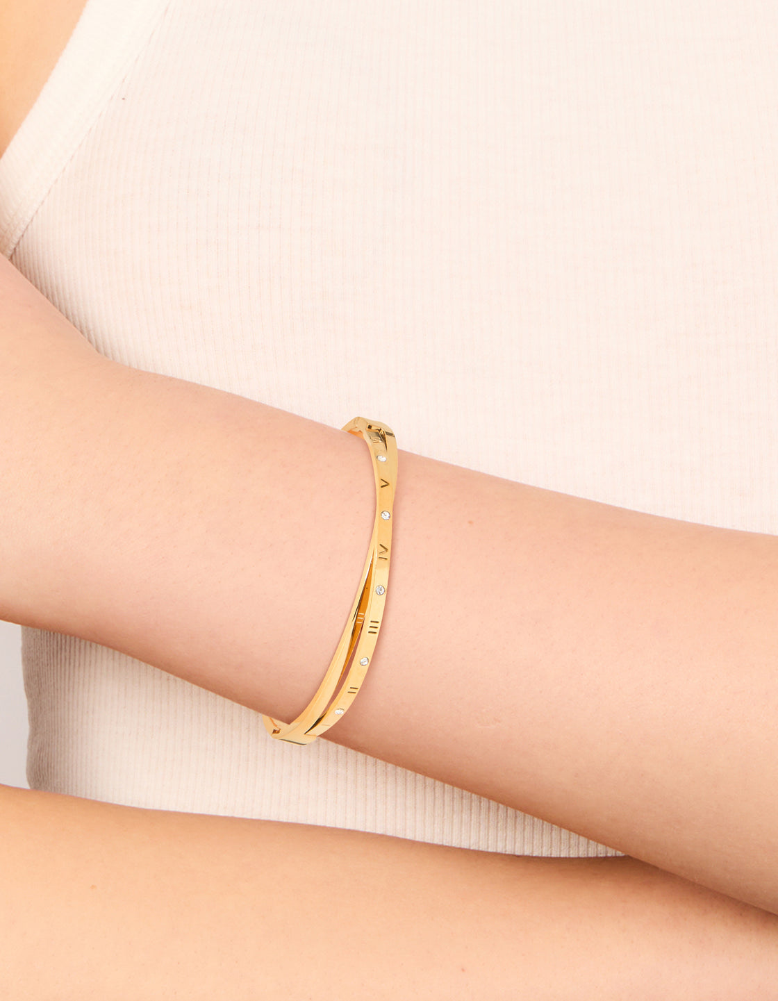 Discover this waterproof gold plated stainless steel diamante roman numeral hinged bangle with statement style on wrist view