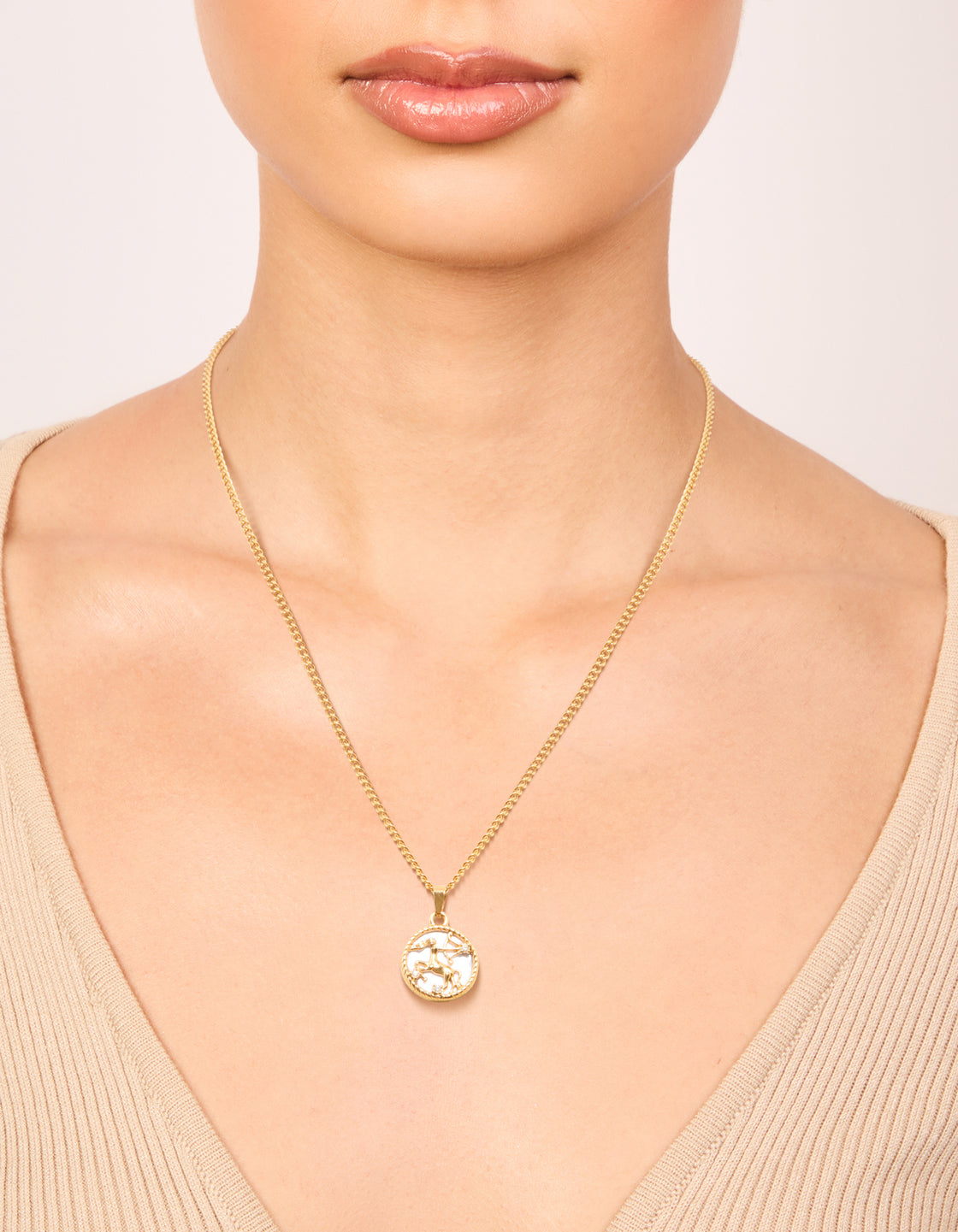 Showcasing a waterproof gold plated stainless steel necklace with a Sagittarius star sign pendant on neck view