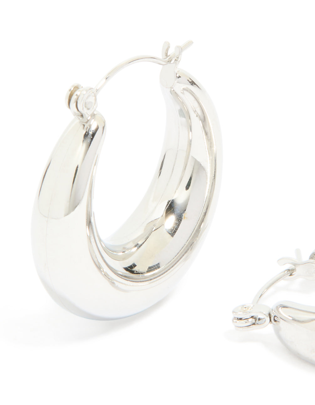 Highlighting waterproof stainless steel small chunky huggie earrings with closure in silver close up view