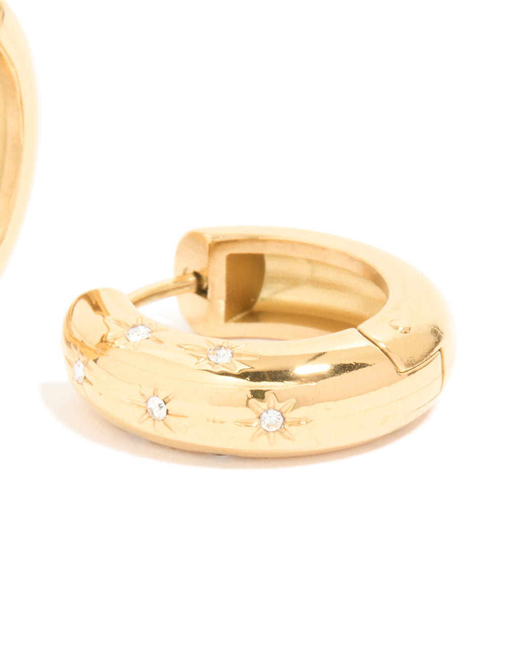 Waterproof gold plated stainless steel diamante star huggie earrings with celestial detail and closure mechanism post detail view