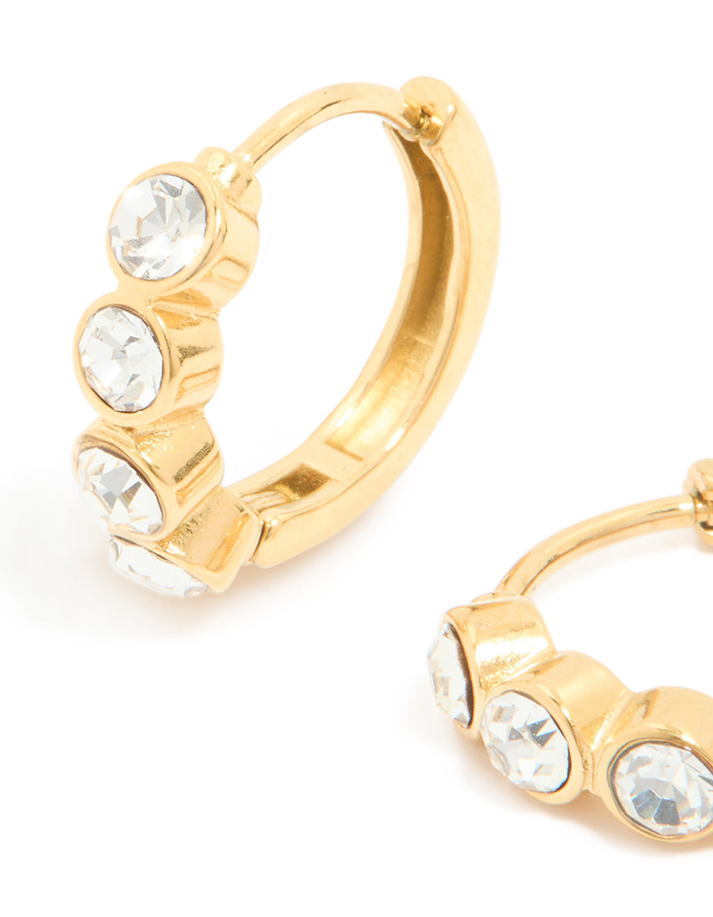 Crafted from waterproof gold plated stainless steel with cubic zirconia bezel huggie closure and clear stones close up view