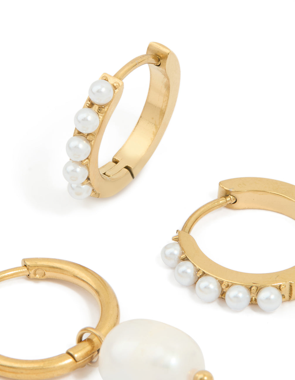 Featuring waterproof gold plated stainless steel pearl detail huggie earrings in a 2-pack with close up view