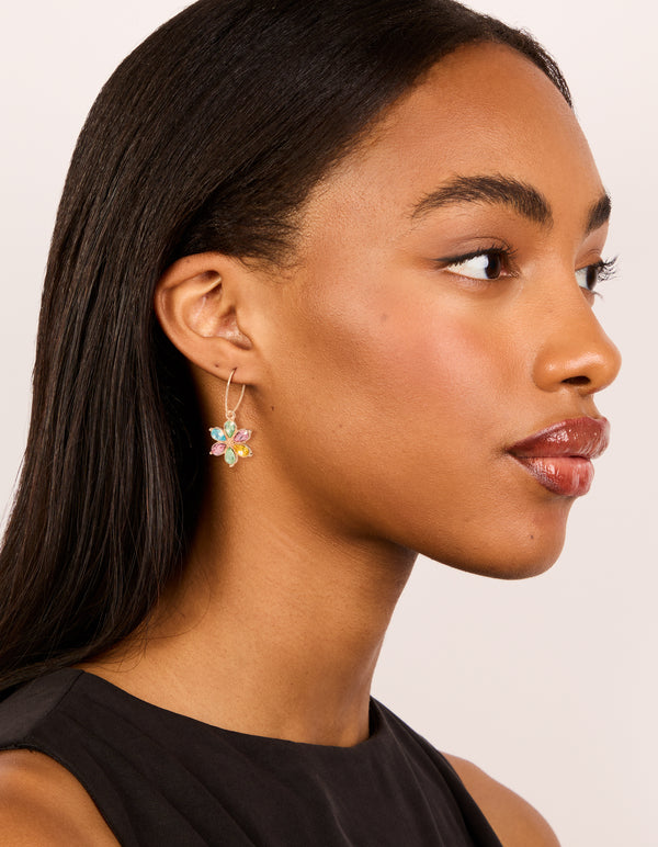 Designed with gold multicoloured diamante flower huggie earrings with pink, yellow, and aqua accents in huggie closure on model view