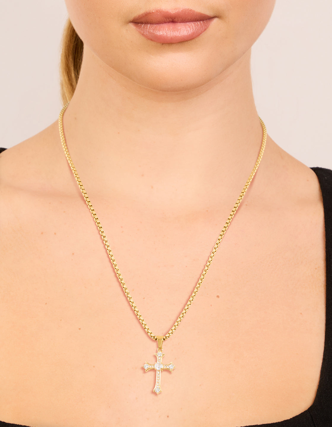 Featuring a waterproof gold plated stainless steel gothic cross pendant necklace with dainty style on neck view