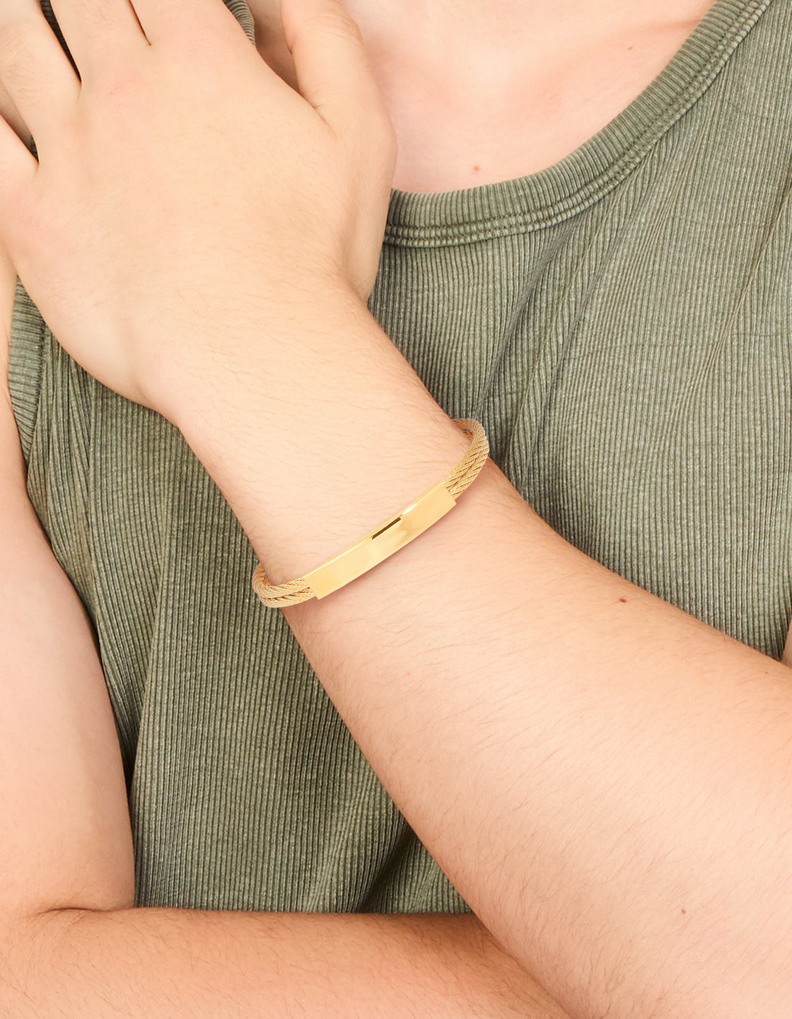 Featuring this mens waterproof twin wire twist wrist cuff in gold plated stainless steel with bar detail on wrist view