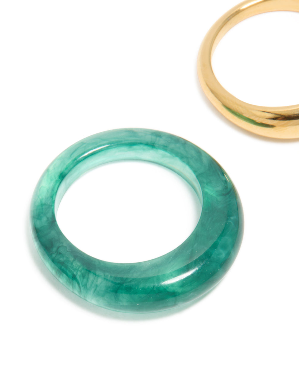 Showcasing waterproof gold plated stainless steel and teal modern thin stacking rings in a 2-pack close up view