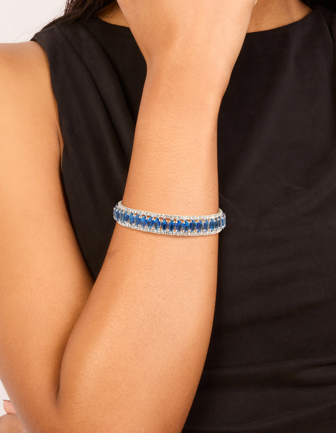 Featuring a silver mini blue diamantes wrist cuff bangle on wrist view