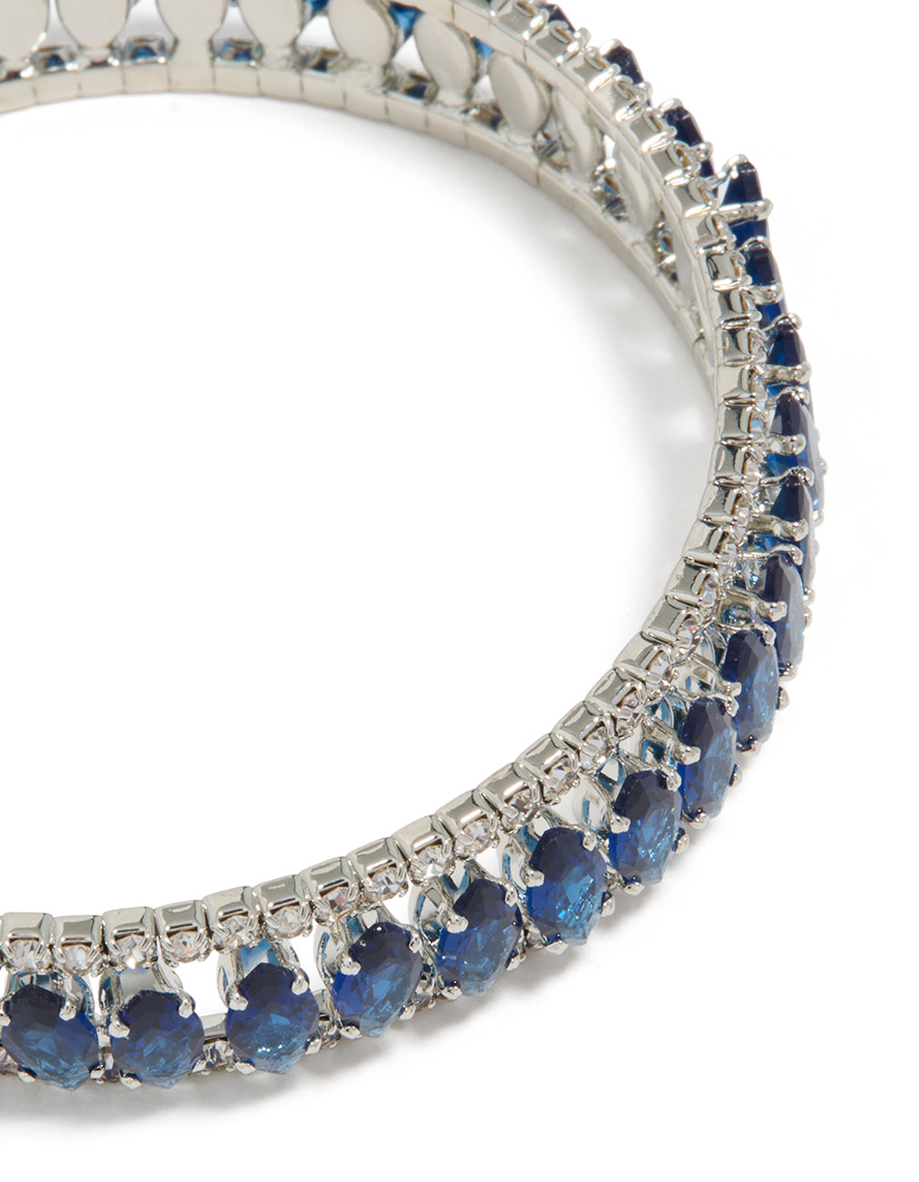 Designed with silver and mini blue diamantes, this wrist cuff bangle highlights intricate stone settings in close up view