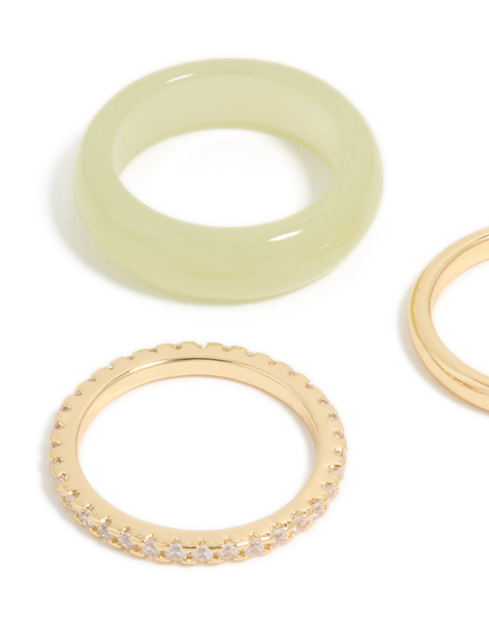 Showcasing gold plated acrylic and cubic zirconia rings in a statement 3-pack close up view