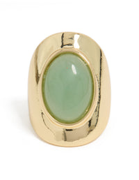 Featuring a gold plated band with oval pale green semi precious stone close up view - link has visual effect only