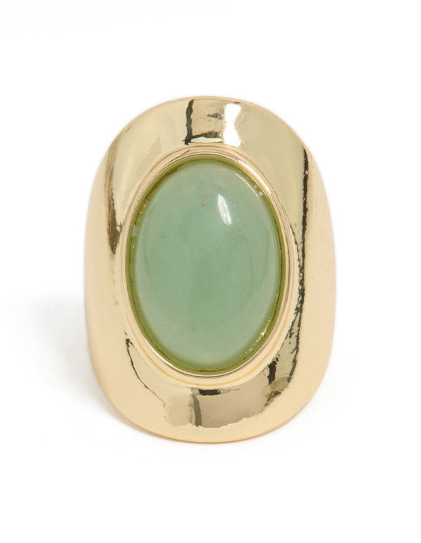 Featuring a gold plated band with oval pale green semi precious stone close up view
