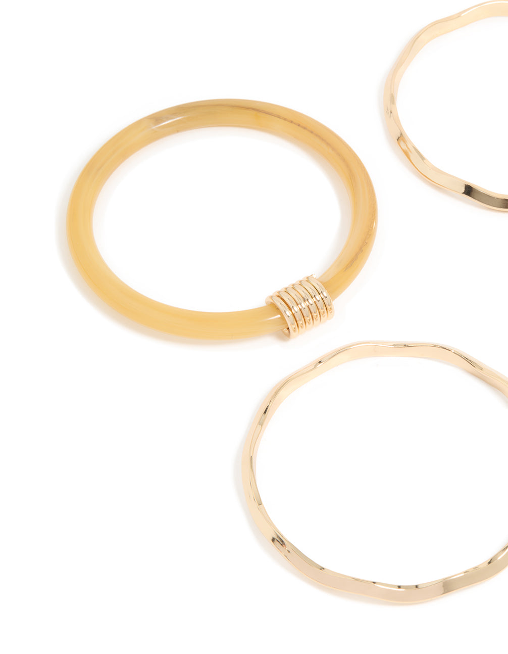 Showcasing neutral acrylic and gold wavy bangles in a 4-pack close up view