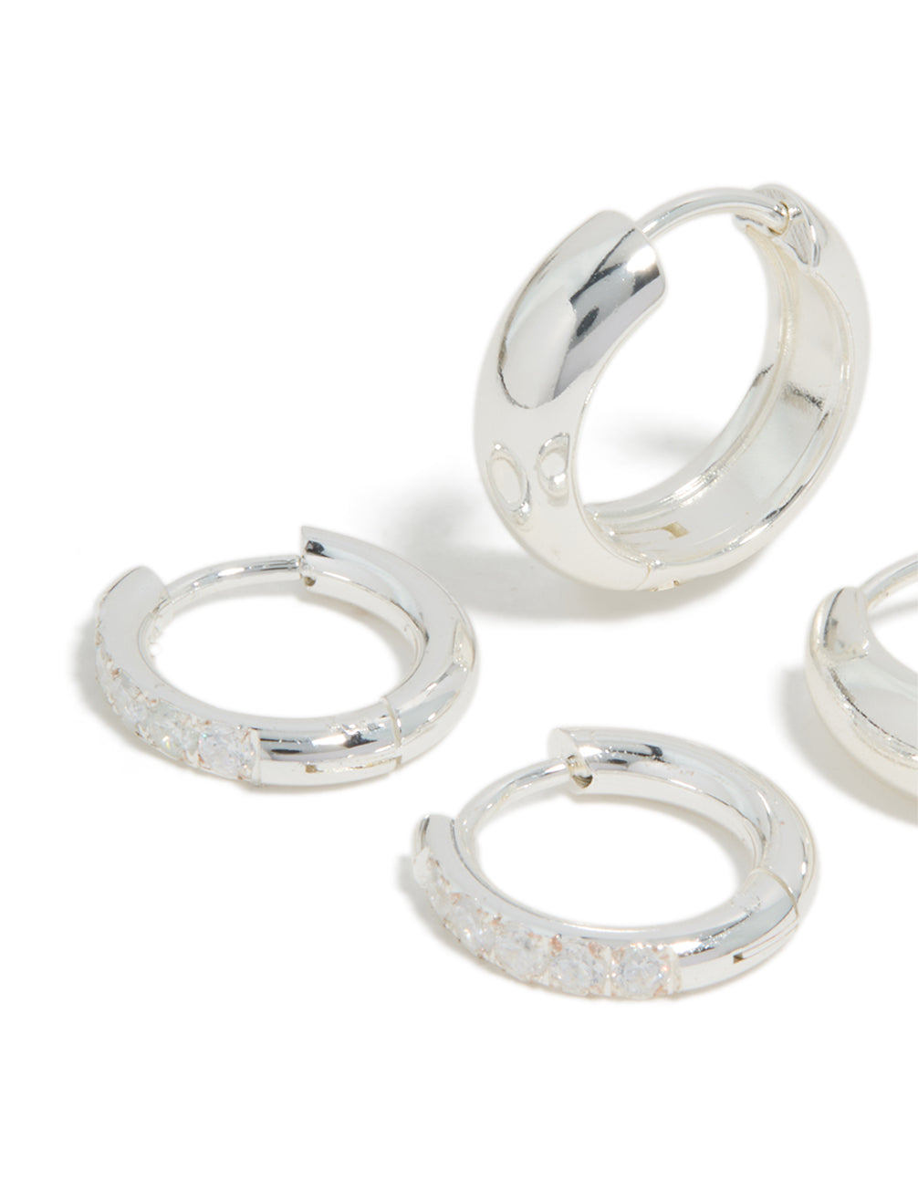 Designed with waterproof stainless steel cubic zirconia chubby huggie earrings 2-pack featuring crystal embellishments and hoop closure in silver close up view
