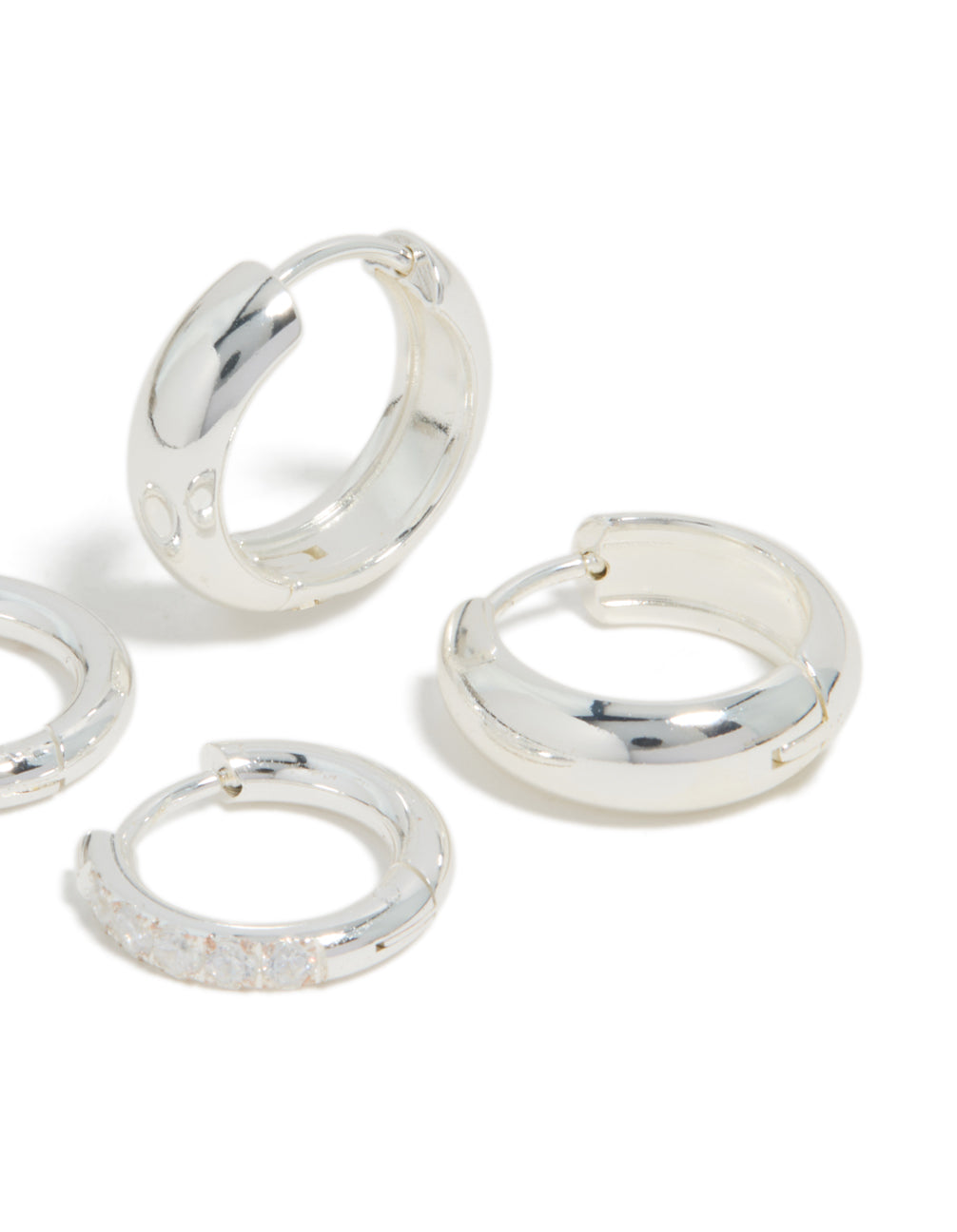 Crafted from waterproof stainless steel cubic zirconia chubby huggie earrings 2-pack with crystal and hoop closure in silver post detail view