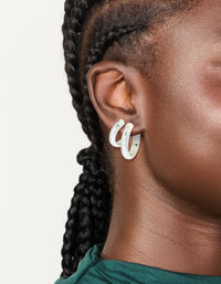 Showcasing these chunky waterproof stainless steel thick hoop earrings in silver in a 2-pack on ear view - link has visual effect only