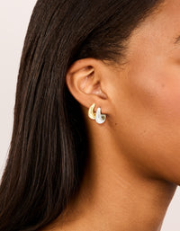 Featuring waterproof mixed metal plated stainless steel tapered mini huggie earrings in a 2-pack with gold and silver tones on ear - link has visual effect only