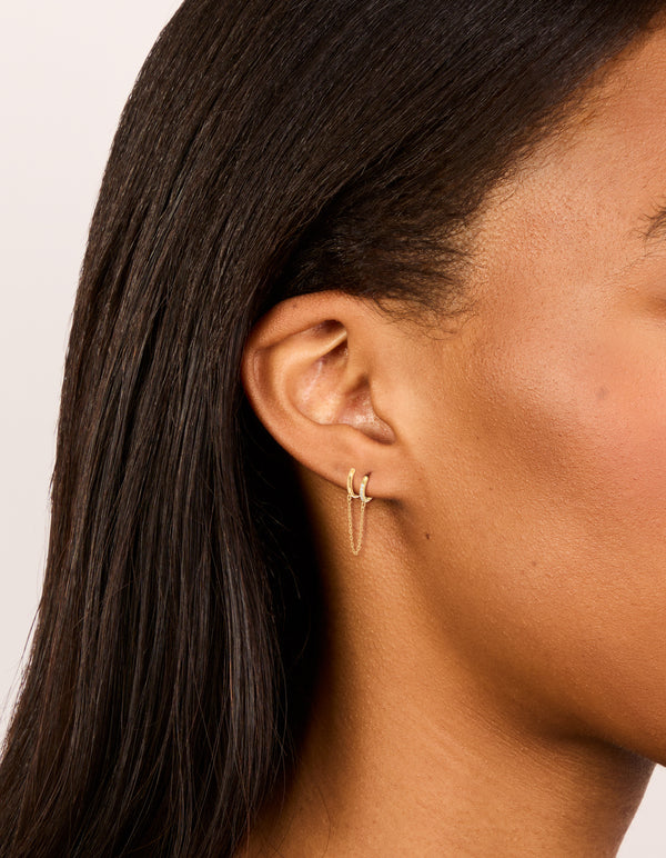 Showcasing waterproof chain link huggie earrings in a 2-pack, crafted from gold plated stainless steel with cubic zirconia on ear view