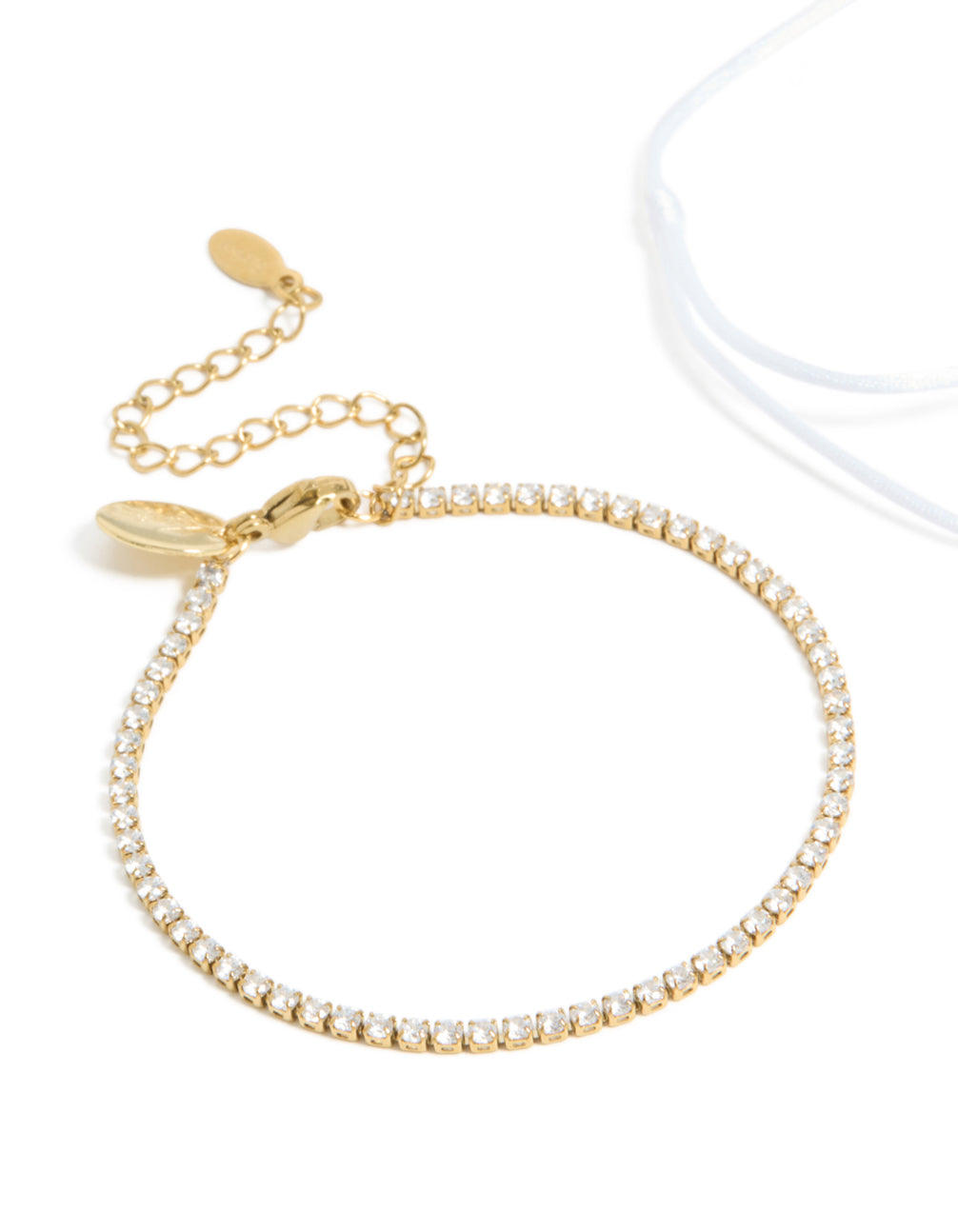 Beautiful waterproof gold plated stainless steel bracelet set with oval cut cubic zirconia tennis and white cord close up view