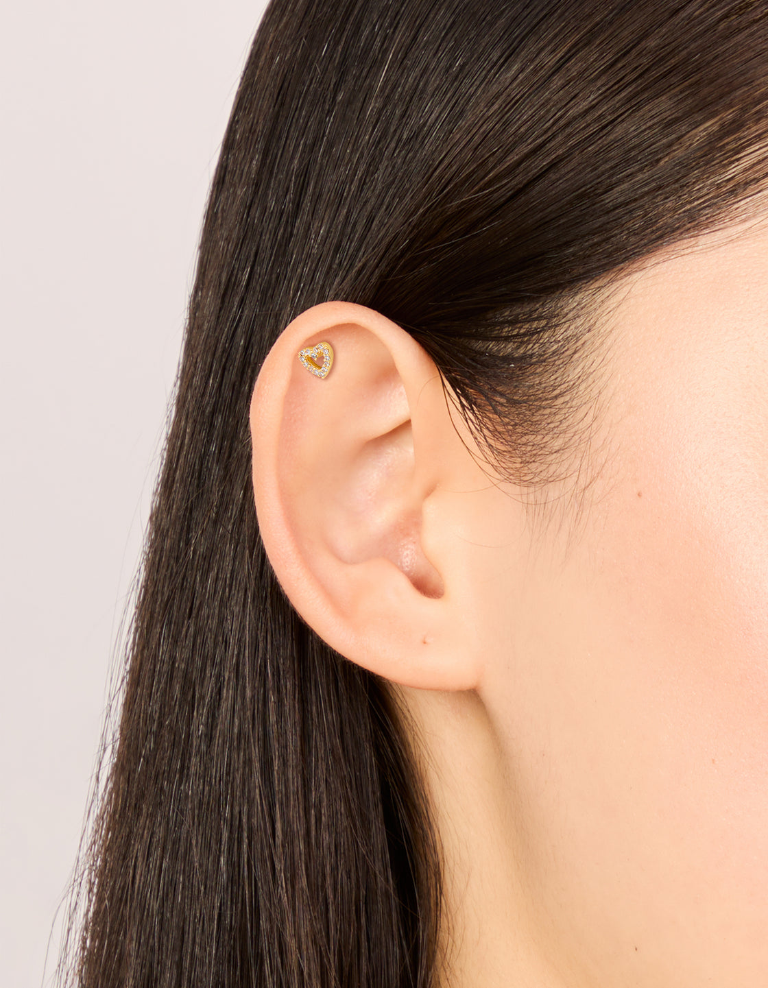 Beautifully designed these open heart gold plated titanium flat back stud earrings with cubic zirconia on ear view