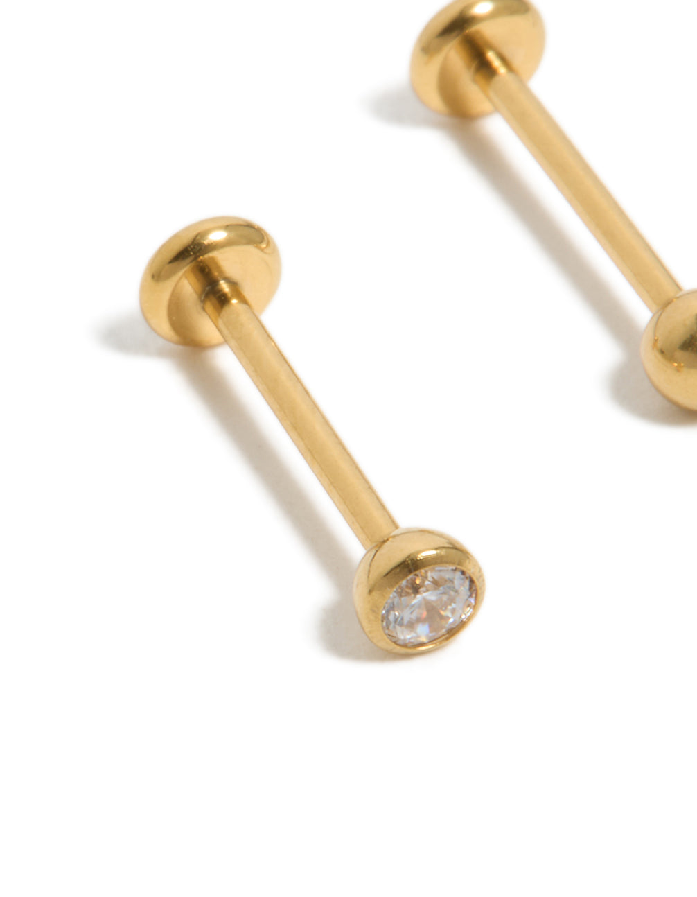 Highlighting gold-plated titanium bezel threadless flat back nose studs crafted with ball accents and diamond embellishments close up view