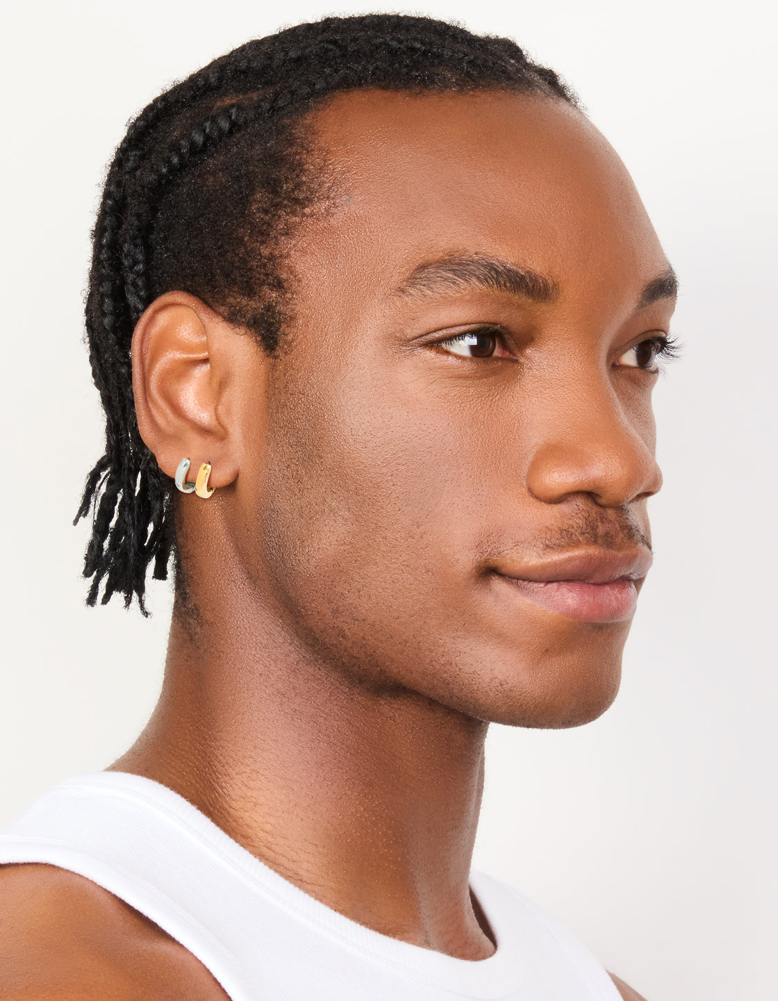 Featuring mens waterproof mixed plated stainless steel huggie earrings in a 2-pack with gold and silver tones on model view