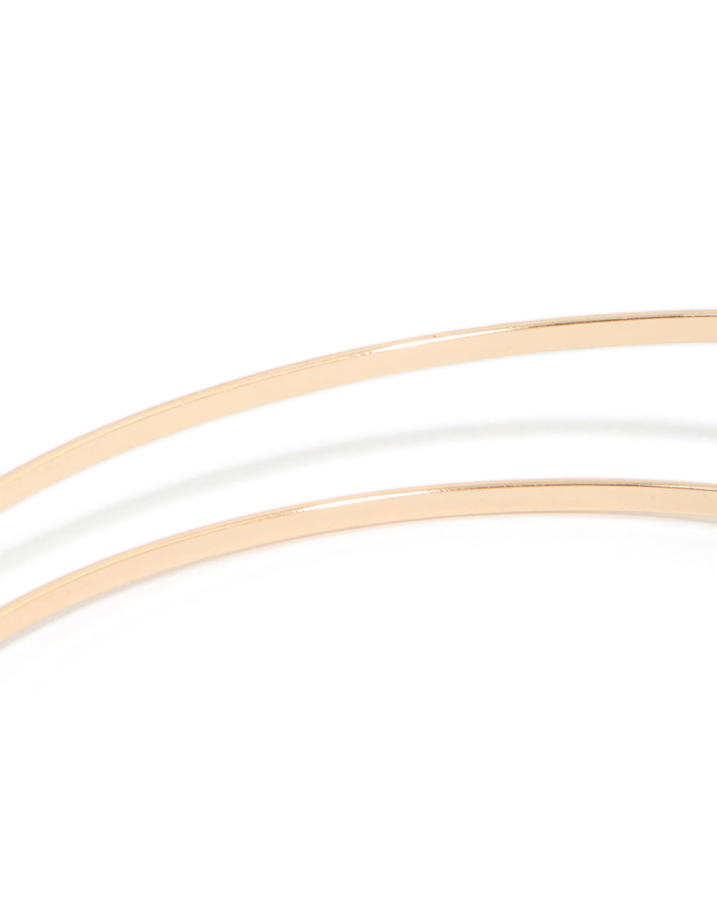 A gold small flower arm cuff with white floral details in close up view
