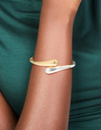 Crafted from gold and silver plated metal, this mixed wrap around bangle showcases a sleek design on wrist view - link has visual effect only