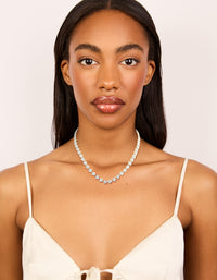 Sophisticated silver plated cubic zirconia multi flower necklace in statement style on model view - link has visual effect only