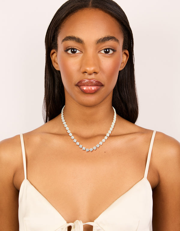 Sophisticated silver plated cubic zirconia multi flower necklace in statement style on model view
