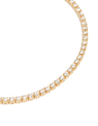Capturing a dainty gold plated cubic zirconia mini tennis toggle bracelet close up view - link has visual effect only