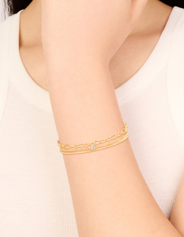 Showcasing gold plated cubic zirconia and chain bracelets in a 3-pack on wrist view