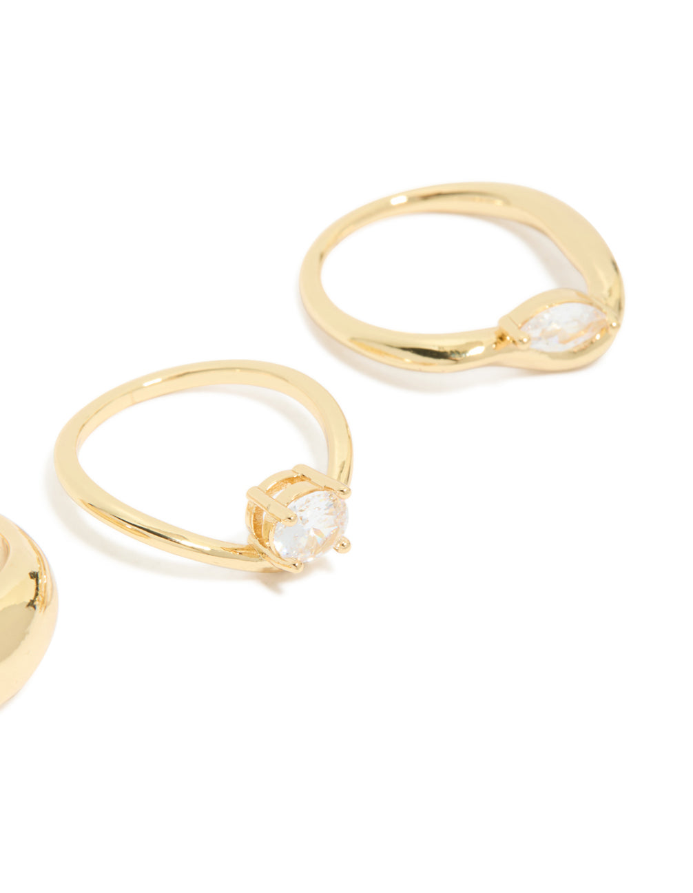 Close view of gold plated cubic zirconia and chunky rings 3-pack with oval cut crystal in statement design close up view