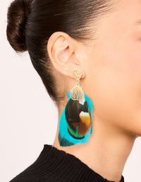 Discover statement drop earrings in gold with feather details and turquoise, brown accents on ear view - link has visual effect only