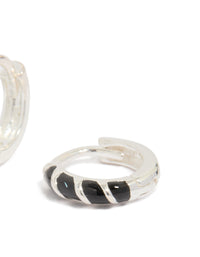 Designed with sterling silver and black striped enamel, these huggie earrings include hoop closure post detail view - link has visual effect only
