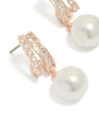 Elegant rose gold plated cubic zirconia illusion pearl drop earrings with hoop closure in ivory close up view - link has visual effect only